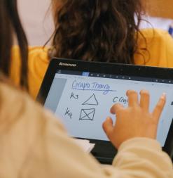 A student using a tablet to study graph theory